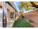 Landscaped backyard with covered patio and seating area at 10509 Ingelow Ct, Las Vegas, NV 89166