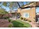 Landscaped backyard with artificial turf and a covered patio at 10509 Ingelow Ct, Las Vegas, NV 89166