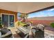 Covered patio with fire pit and seating area, overlooking a landscaped backyard at 10509 Ingelow Ct, Las Vegas, NV 89166