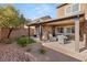 Covered patio and seating area in a landscaped backyard at 10509 Ingelow Ct, Las Vegas, NV 89166