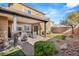 Covered patio with seating area and fire pit in a landscaped backyard at 10509 Ingelow Ct, Las Vegas, NV 89166