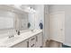 Modern bathroom with dual sinks, a large mirror, and an updated shower at 10509 Ingelow Ct, Las Vegas, NV 89166