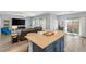 Open kitchen features a large island with seating and modern cabinetry at 10509 Ingelow Ct, Las Vegas, NV 89166