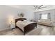 Spacious main bedroom with a large bed, ceiling fan, and sitting area at 10509 Ingelow Ct, Las Vegas, NV 89166