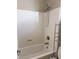 Clean bathroom featuring a shower-tub combo, white tiling, and sleek fixtures at 12243 Pacific Cruise Ave, Las Vegas, NV 89138
