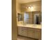 Well-lit bathroom features double sinks, white cabinetry and modern fixtures at 12243 Pacific Cruise Ave, Las Vegas, NV 89138