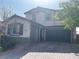 Two story home featuring a 3-car garage and a paved driveway leading up to the front of the house at 12243 Pacific Cruise Ave, Las Vegas, NV 89138