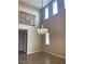 Living room featuring high ceilings, wood look tile floors, and a decorative chandelier at 12243 Pacific Cruise Ave, Las Vegas, NV 89138