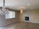 Living room featuring wood look tile floors, fireplace, and a decorative chandelier at 12243 Pacific Cruise Ave, Las Vegas, NV 89138