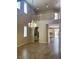 Bright open living space with high ceilings, wood look tile floors, and a decorative chandelier at 12243 Pacific Cruise Ave, Las Vegas, NV 89138