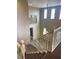 A well-lit two-story foyer featuring staircase with white railing and chandelier at 12243 Pacific Cruise Ave, Las Vegas, NV 89138