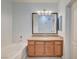 Bathroom featuring a tub and shower combo, vanity with granite countertop, and large mirror at 1701 King James St # 101, Las Vegas, NV 89144