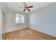 Bedroom with wood-look floors, bright natural light, and ceiling fan at 1701 King James St # 101, Las Vegas, NV 89144
