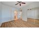 Spacious bedroom featuring ceiling fan, wood-look flooring, and mirrored closet doors at 1701 King James St # 101, Las Vegas, NV 89144