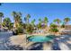 Inviting community hot tub surrounded by lush landscaping and palm trees, perfect for relaxation at 1701 King James St # 101, Las Vegas, NV 89144