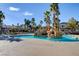 Resort-style pool area with rock features and palm trees, offering a luxurious outdoor experience for residents at 1701 King James St # 101, Las Vegas, NV 89144