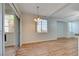Bright dining area with wood flooring, chandelier, and view of living room and kitchen at 1701 King James St # 101, Las Vegas, NV 89144