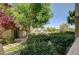 Exterior view of the apartment complex entryway with landscaped walkway and lush greenery at 1701 King James St # 101, Las Vegas, NV 89144