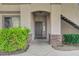 Charming condo front entrance with lush greenery and stone accents, creating a welcoming curb appeal at 1701 King James St # 101, Las Vegas, NV 89144