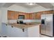 Well-equipped kitchen with wood cabinets, granite countertops, and stainless steel appliances at 1701 King James St # 101, Las Vegas, NV 89144