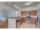Eat-in kitchen featuring stainless steel appliances, wood cabinetry, and a breakfast bar at 1701 King James St # 101, Las Vegas, NV 89144