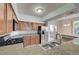 Modern kitchen with granite countertops, stainless steel appliances, and wood cabinets at 1701 King James St # 101, Las Vegas, NV 89144