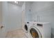 Well-lit laundry room featuring side-by-side washer and dryer and tile floors at 1701 King James St # 101, Las Vegas, NV 89144