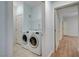 Well-lit laundry room with side-by-side washer and dryer and tile floors at 1701 King James St # 101, Las Vegas, NV 89144