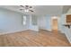 Light-filled open living area features wood flooring with views of entrance and bathroom at 1701 King James St # 101, Las Vegas, NV 89144