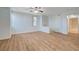 Open living room with wood flooring that flows into hallway and bathroom at 1701 King James St # 101, Las Vegas, NV 89144