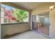 View from the patio through sliding glass doors into the bright dining room with wood floors at 1701 King James St # 101, Las Vegas, NV 89144
