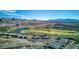 Aerial view of houses and golf course in mountainous region at 25 Via Corvina, Henderson, NV 89011