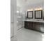 Modern bathroom with double vanity, large shower and dark brown cabinets at 25 Via Corvina, Henderson, NV 89011