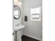 Simple and clean powder room with pedestal sink and dark hardwood floors at 25 Via Corvina, Henderson, NV 89011