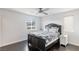 Cozy bedroom with dark hardwood floors and a ceiling fan at 25 Via Corvina, Henderson, NV 89011
