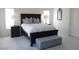 Primary bedroom with a king-size bed and gray accents at 25 Via Corvina, Henderson, NV 89011
