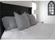 Primary bedroom with plush bedding and large windows at 25 Via Corvina, Henderson, NV 89011