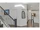 Elegant entryway with staircase and view into the kitchen at 25 Via Corvina, Henderson, NV 89011