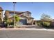 Two-story house with gray garage door and landscaping at 25 Via Corvina, Henderson, NV 89011