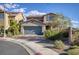Two-story house with gray garage door and landscaping at 25 Via Corvina, Henderson, NV 89011