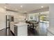 Open concept kitchen with island and stainless steel appliances at 25 Via Corvina, Henderson, NV 89011