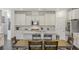 Modern kitchen with white cabinets, island, and stainless steel appliances at 25 Via Corvina, Henderson, NV 89011