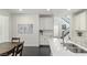 Modern kitchen with white cabinets, stainless steel appliances, and double sink at 25 Via Corvina, Henderson, NV 89011