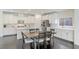 Modern kitchen with white cabinets, kitchen island, and dark hardwood floors at 25 Via Corvina, Henderson, NV 89011