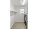 Bright laundry room with washer and dryer and shelving at 25 Via Corvina, Henderson, NV 89011