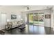 Bright living room with hardwood floors, sliding glass doors to backyard, and neutral decor at 25 Via Corvina, Henderson, NV 89011