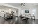 Open concept living room and kitchen with dark hardwood floors and ceiling fan at 25 Via Corvina, Henderson, NV 89011