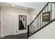 Modern staircase with dark wood steps and a full-length mirror at 25 Via Corvina, Henderson, NV 89011