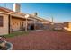 Landscaped backyard with patio, covered seating area and gravel at 2594 Florida Keys Dr, Las Vegas, NV 89156