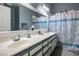 Bathroom with double vanity, shower/tub combo and grey decor at 2594 Florida Keys Dr, Las Vegas, NV 89156